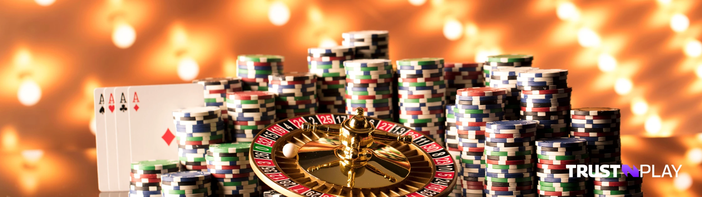 Casino roulette wheel, chips, and playing cards.