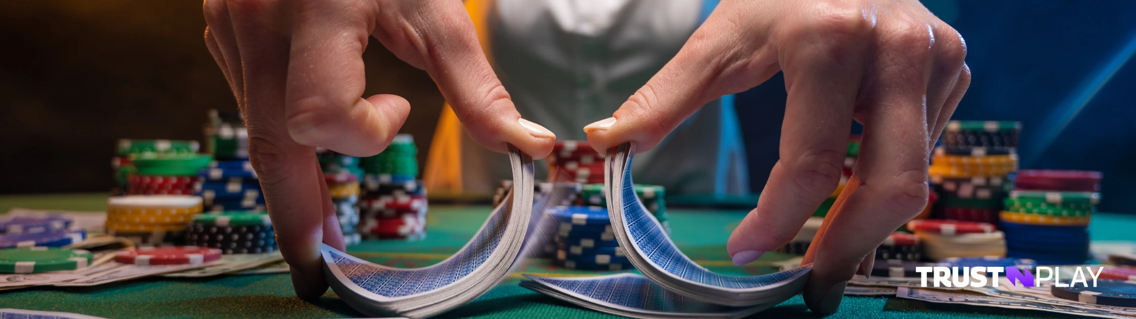 Casino dealer with cards and chips at the table.